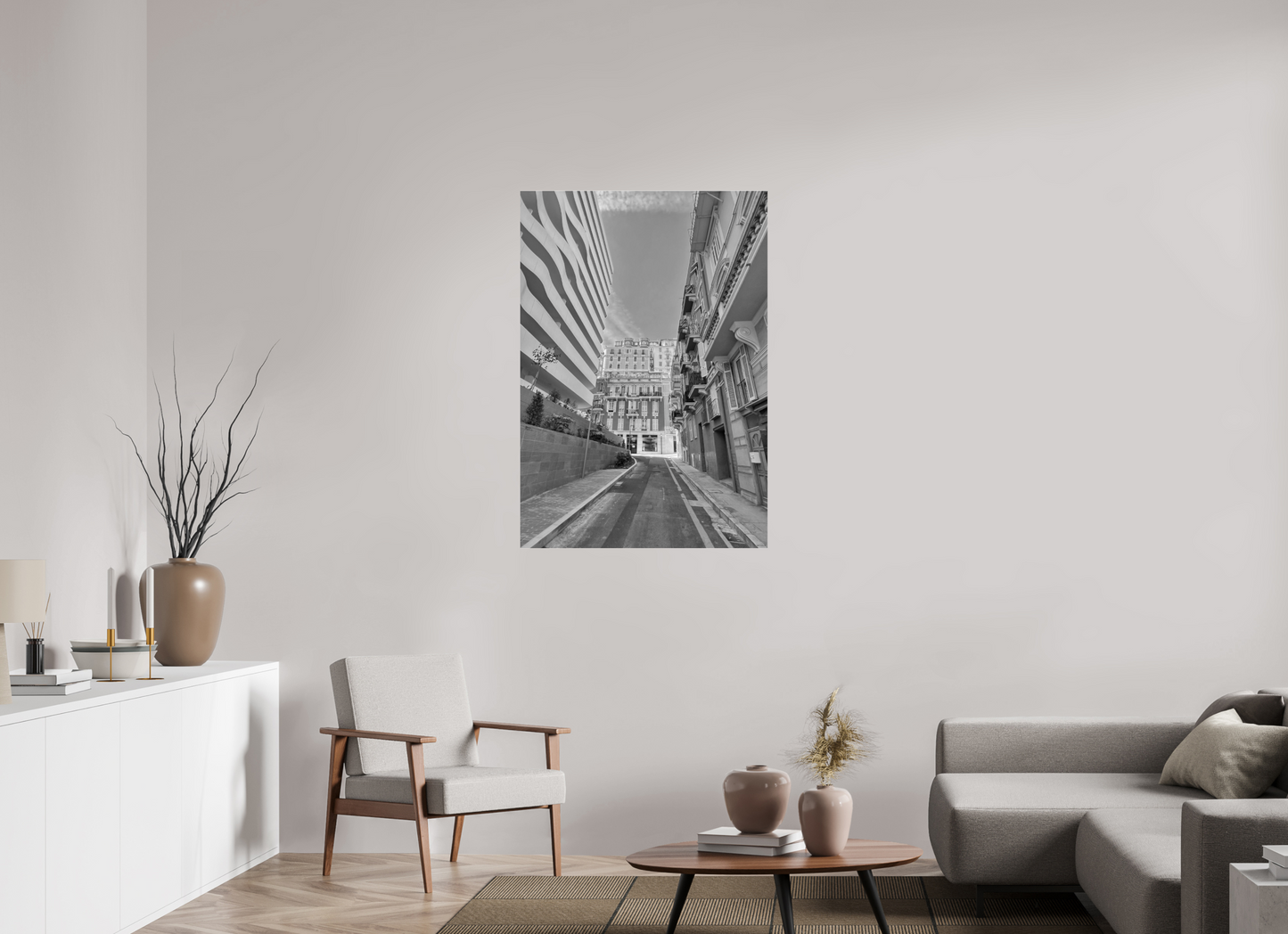 Rectangular grayscale city street wall art print centered on blank wall in living room
