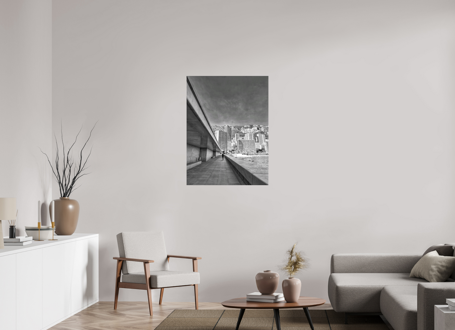 Framed black-and-white city street photo print above living room seating