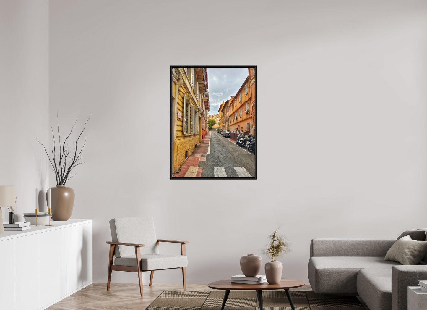 Square framed photo print with a black frame, depicting a narrow street view between tall buildings