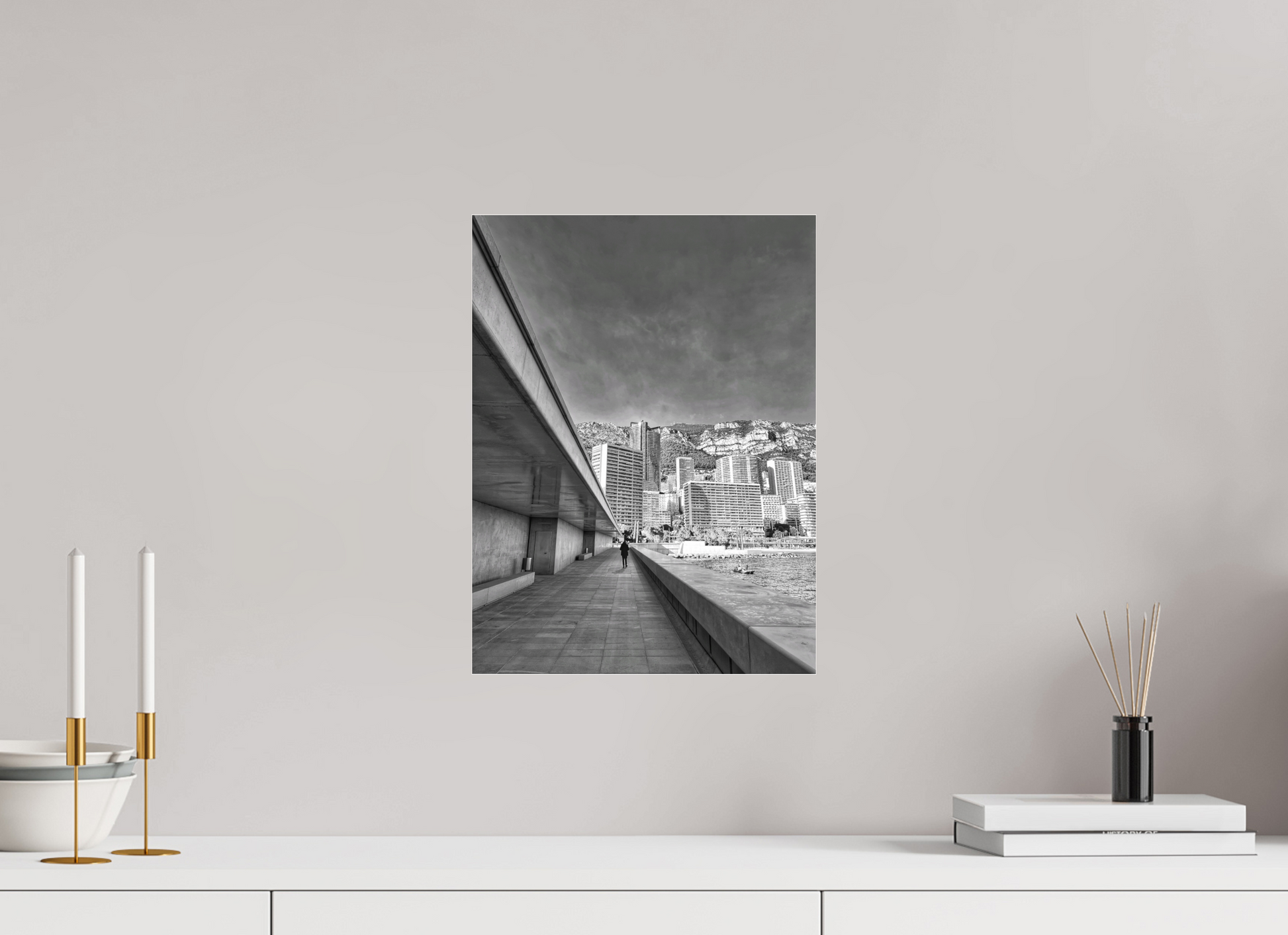 Framed black-and-white city street photo print centered on wall