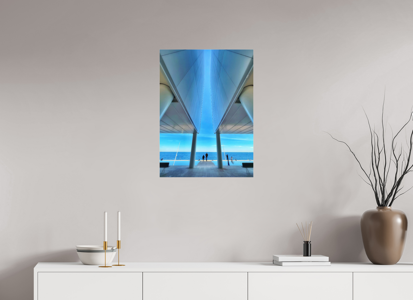 Framed acrylic-glass wall print with blue coastal architecture and distant figures