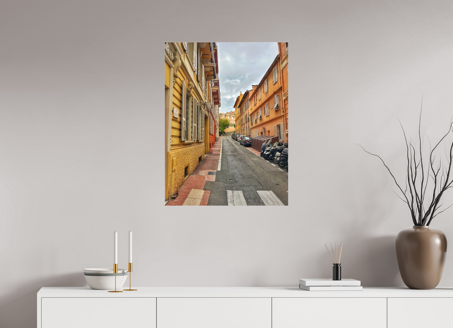 Square street photo print above cabinet, city alley view between tall buildings