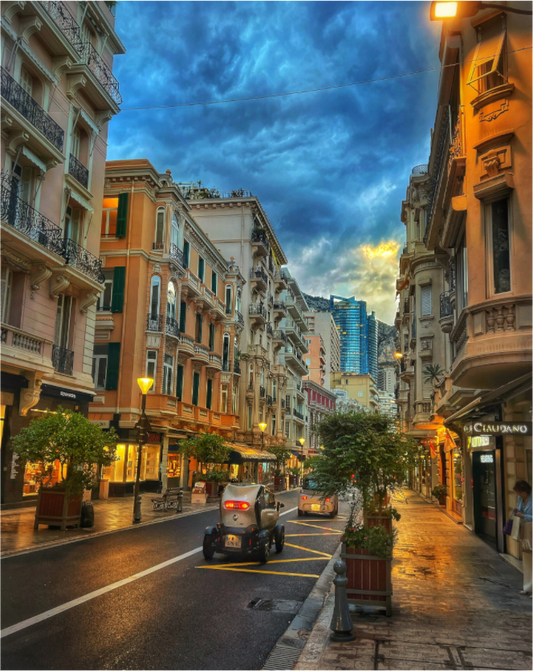 Wall-mounted city street photo in acrylic glass floater frame, blue stormy sky
