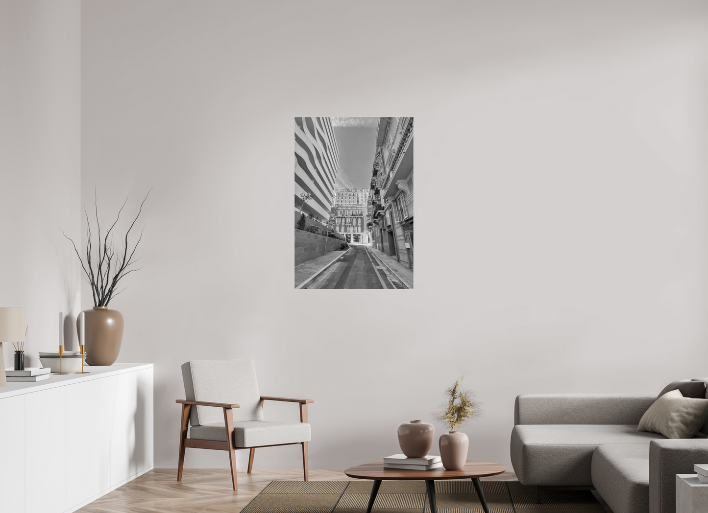 Rectangular grayscale city street wall art print above coffee table in living room