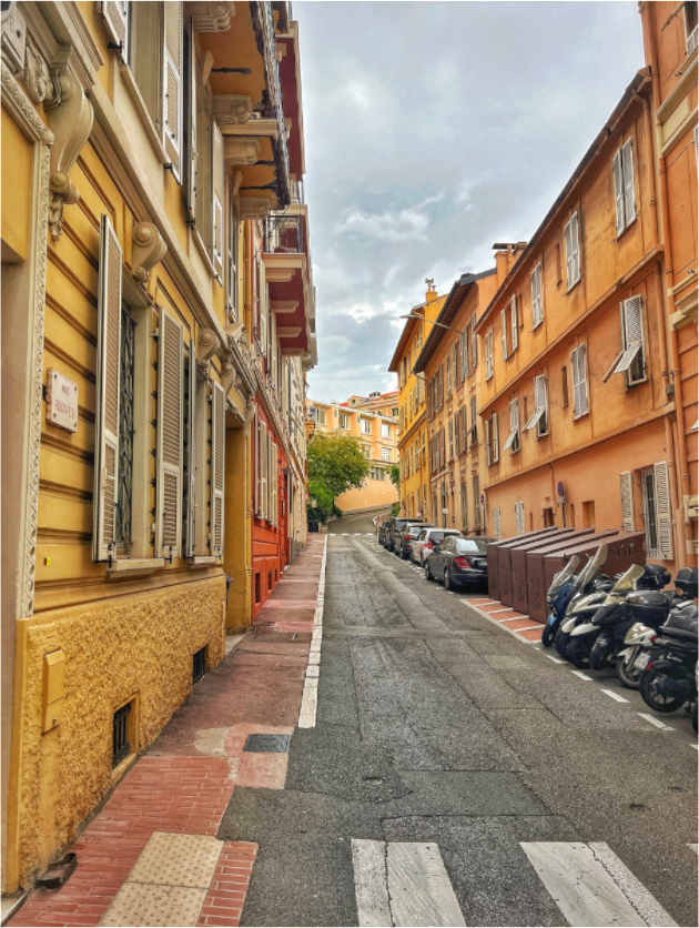 Square street photo print showing a European alley between tall buildings
