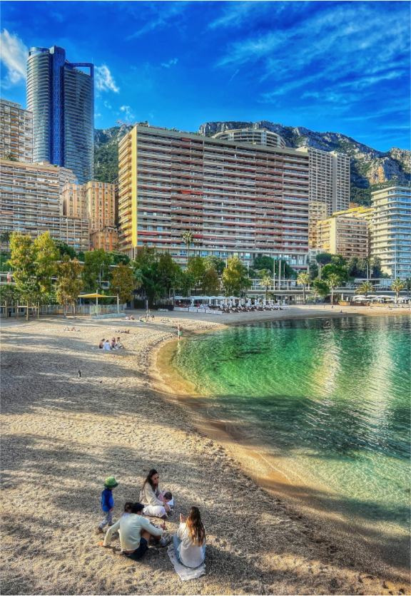 Beach scene wall art: acrylic glass photo print with sand, sea, and buildings